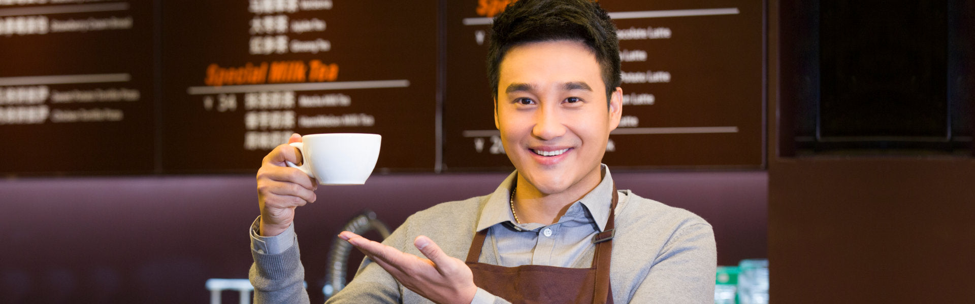 a coffee barista holding a cup